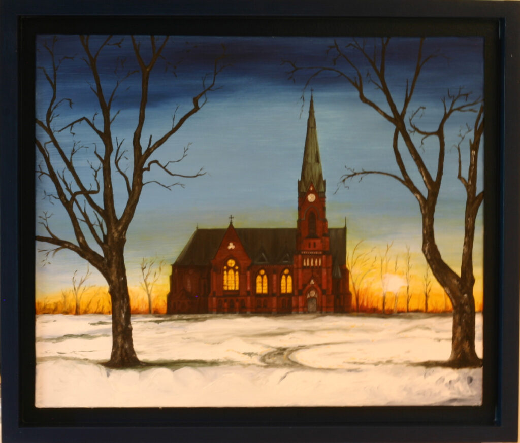 Red brick church in winter landscape with bare trees framing composition, dramatic sunset sky, snow-covered ground showing Gothic architecture
